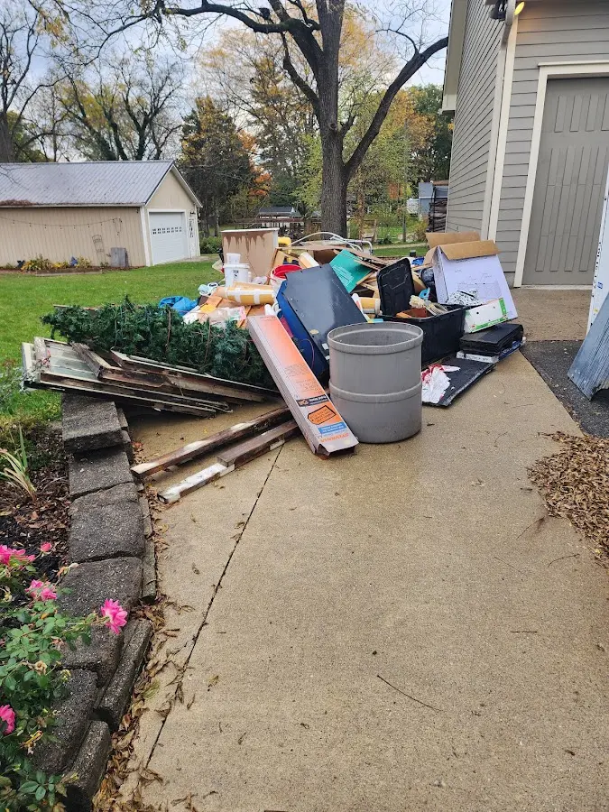 Dumpster being loaded with debris for 3 Yard Dumpster Rental in Lake Park